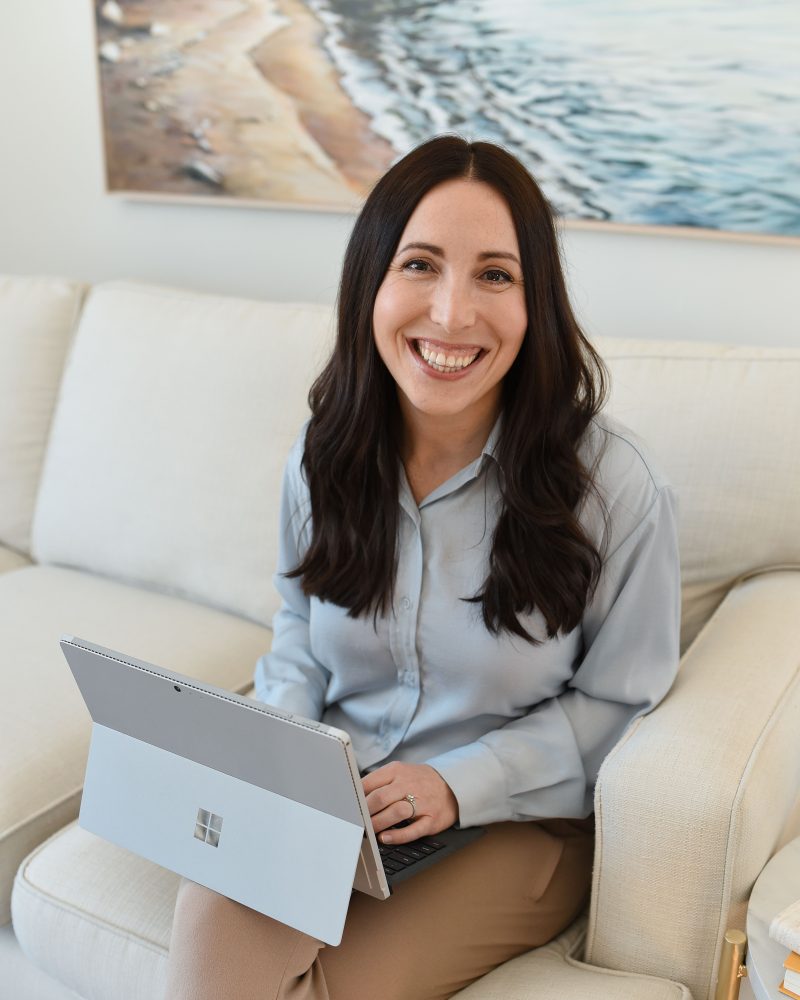 Jacqueline Gokavi smiling on the couch in her counselling office